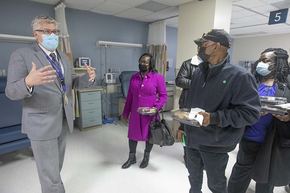 Sean Nelson, director of ambulatory services for primary care at MUSC, gives a tour of the new Rena N. Grant Sickle Cell Center at Rutledge Tower to Rena’s mother, Laura, and other family members.