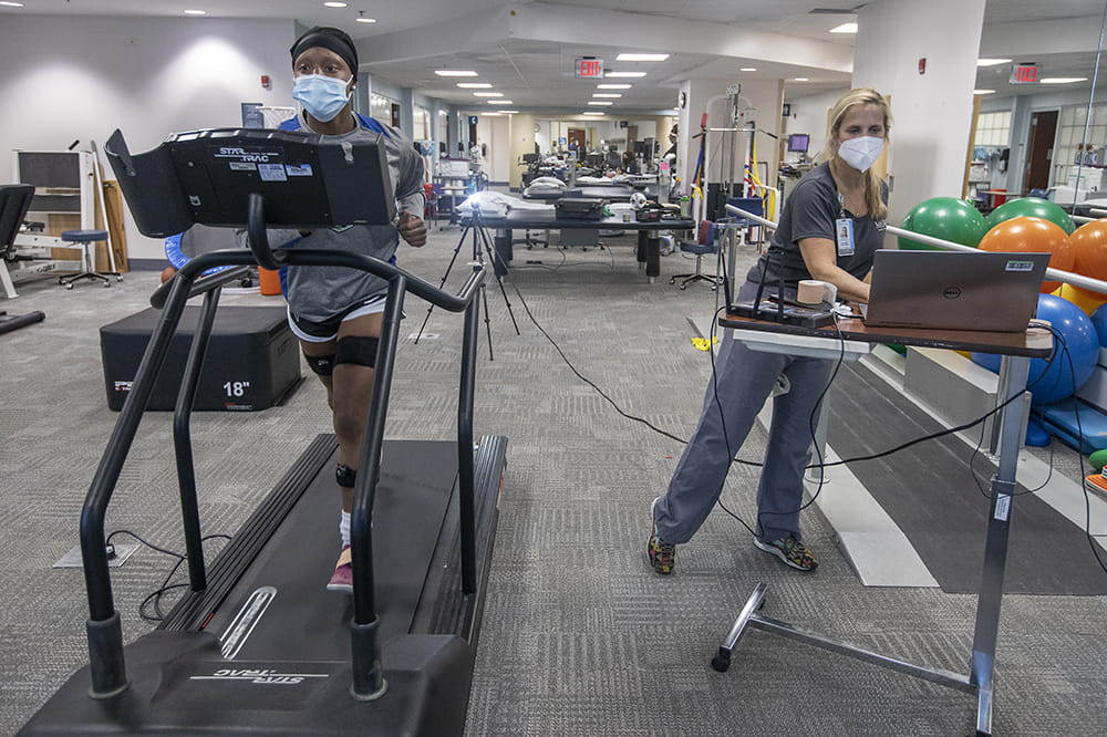 HIgh school soccer player Korbin Heyward, with sensors on areas of her body that physical therapist Stephanie McGowan wants to monitor, runs on a treadmill. Keyward once worried she'd never walk again after a serious injury during a tournament.