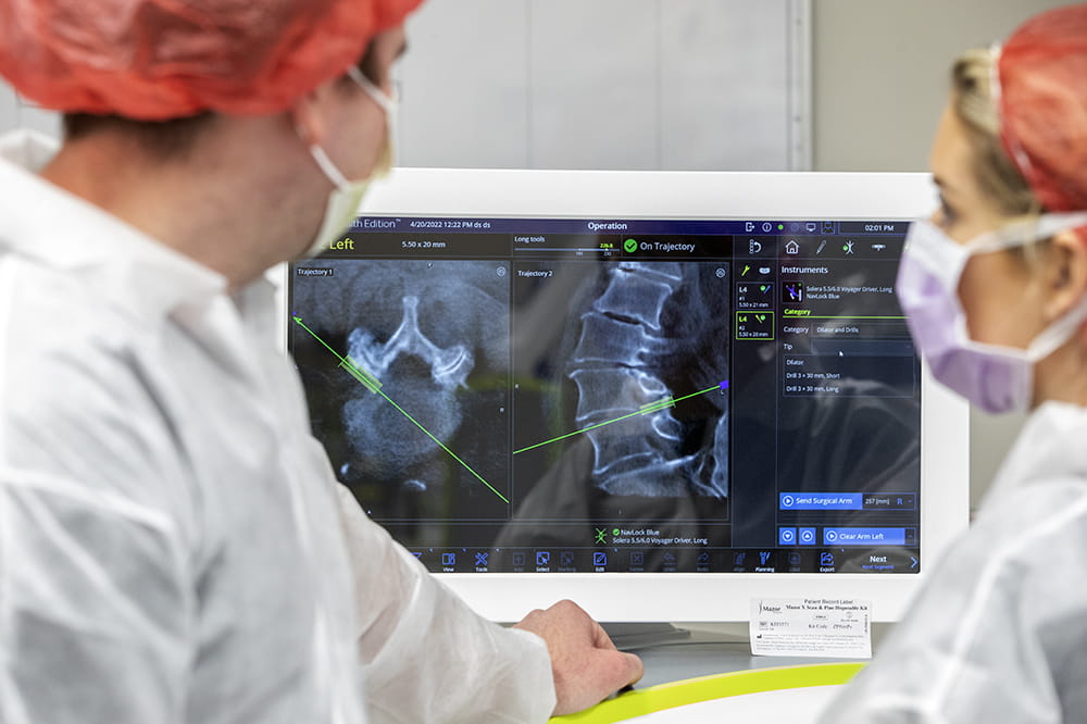 the screen shows the x-ray of the spine and the correct path for instruments