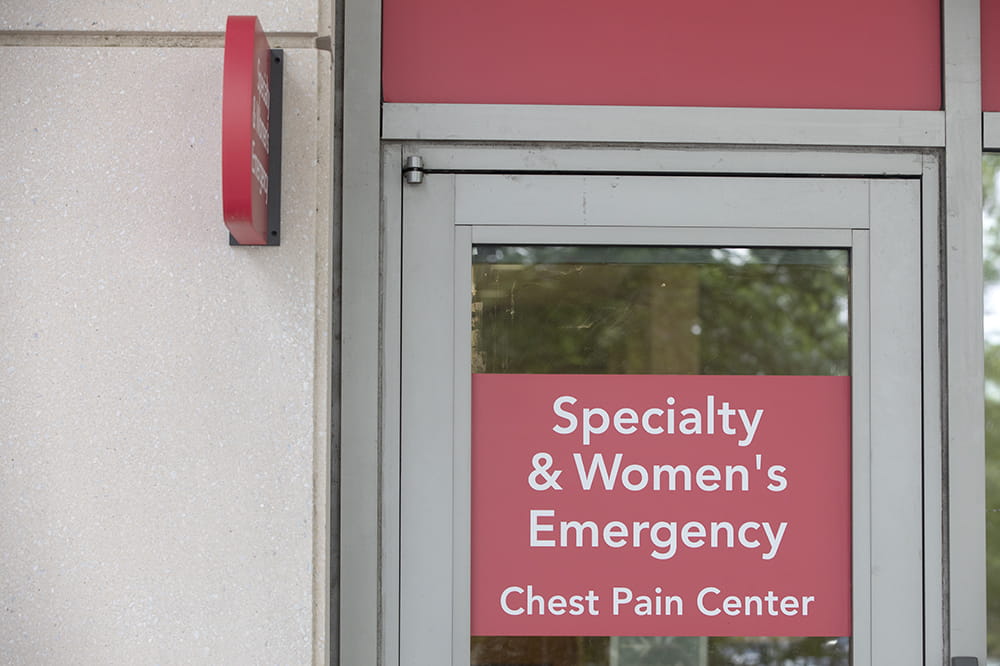 photo of a door with a red sign stating Specialty and Women's Emergency and Chest Pain Center