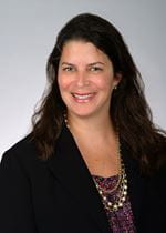 Headshot of smiling woman wearing a blazer