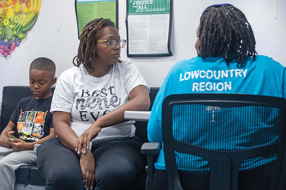 SC DHEC Lowcountry WIC van administrator Alleyah Wilder helps Berkeley County’s Shaneisha McQueen sign up for WIC benefits. McQueen's baby, Trinity Summers, is at the MUSC Shawn Jenkins Children’s Hospital NICU.