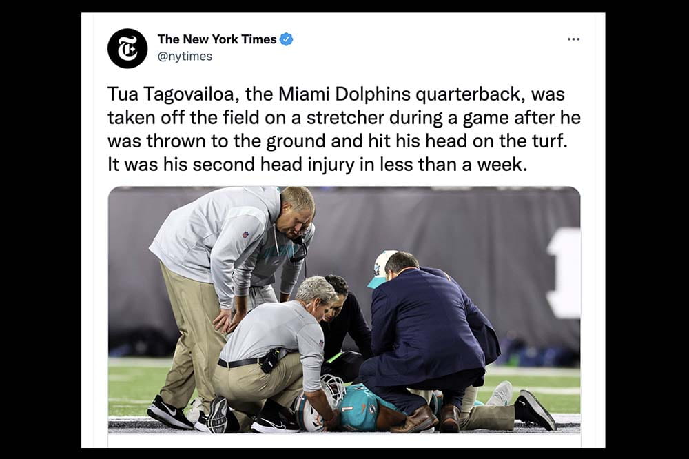 A Tweet from the New York Times shows Tua Tagovailoa lying on football field surrounded by other men checking on him.