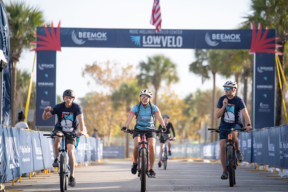 Riders in LOWVELO22 cross the finish line on the Isle of Palms. Photo by Ben Egelson