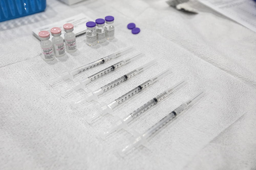 vials and needles laid out on a towel.