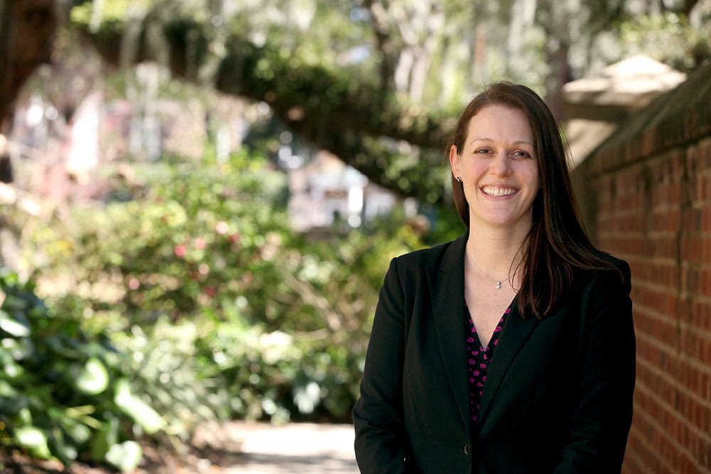 a portrait of a cancer researcher in a garden setting