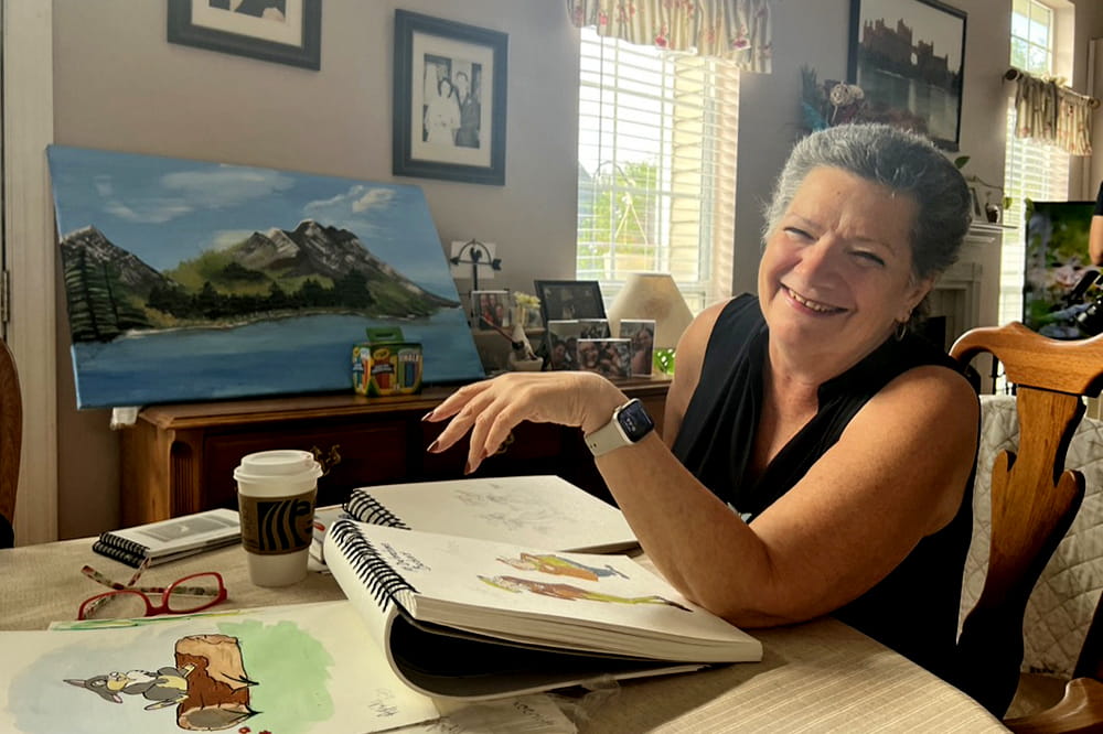 image of a woman smiling and talking at kitchen table