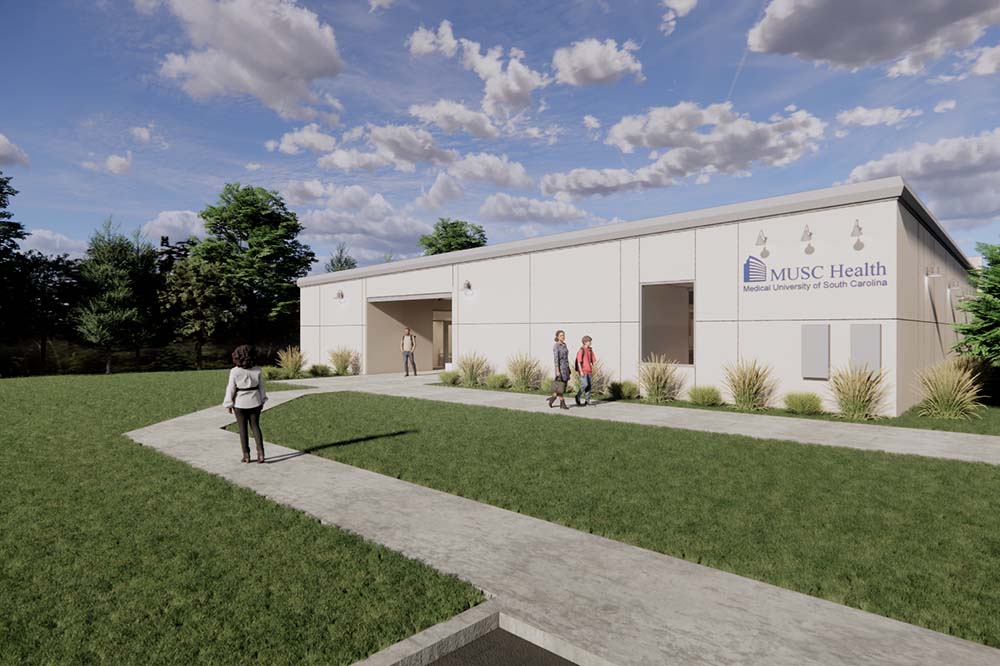 An illustration of a long one-story building. A person is standing on a sidewalk surrounded by grass.