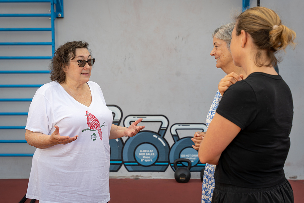 two women listen sympathetically as another talks and gestures with her hands