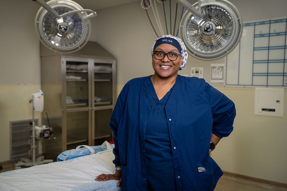a nurse poses in an operating room